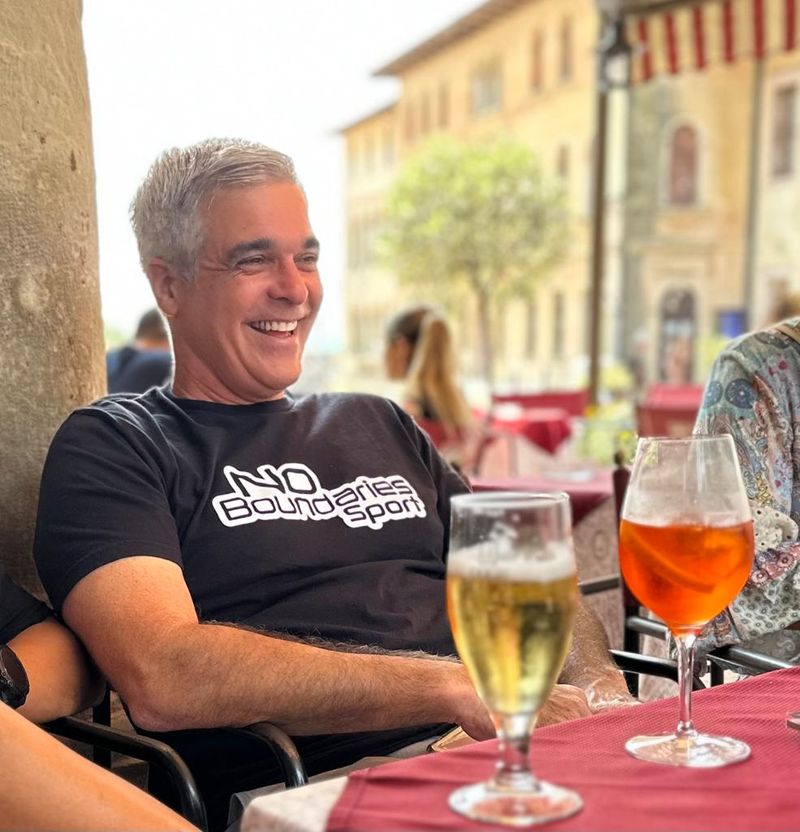 A rider relaxing with a beer and an aperol in a piazza