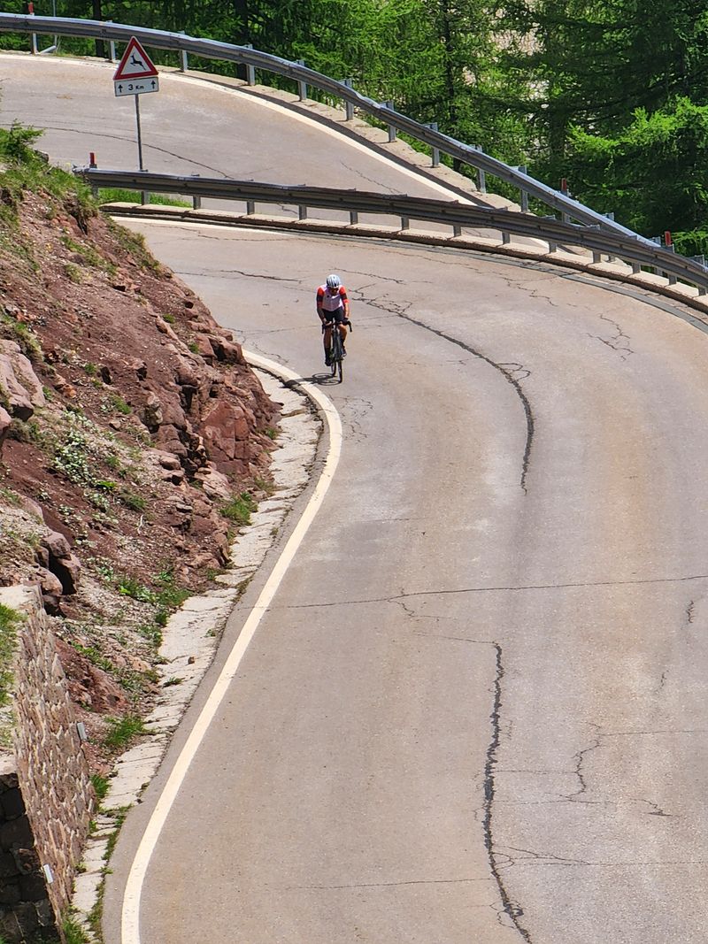 A rider on a wide sweeping mountain bend